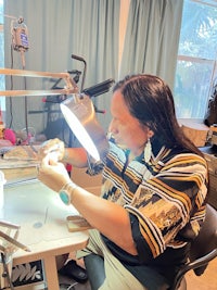 a woman working on her teeth in a dental office