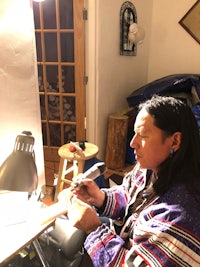 a man sitting at a table with a microphone in front of him